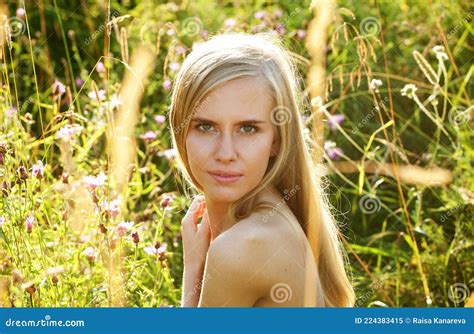 Beautiful Young Female With Blond Hair Posing Nude In Nature On A