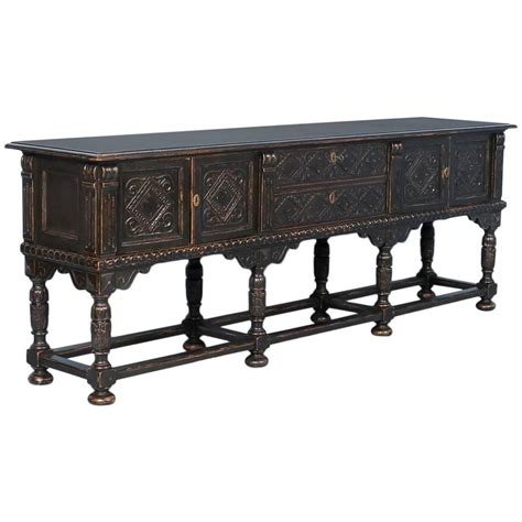 An Ornately Carved Sideboard With Two Drawers On One End And Three