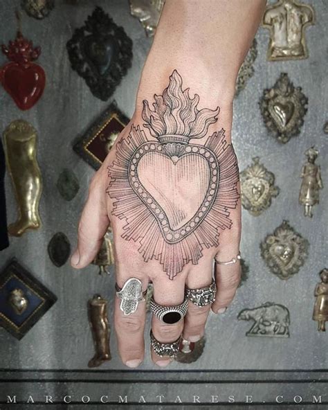 Hand Tattoos Heart In 2020 Heart Tattoo Designs Sacred Heart Tattoos