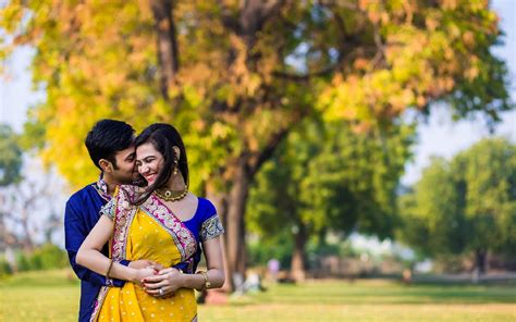 Download Cute Indian Couple In Wedding Attire At Park Wallpaper