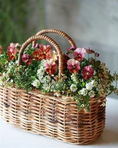 A Basket Filled With Flowers Sitting On Top Of A Table