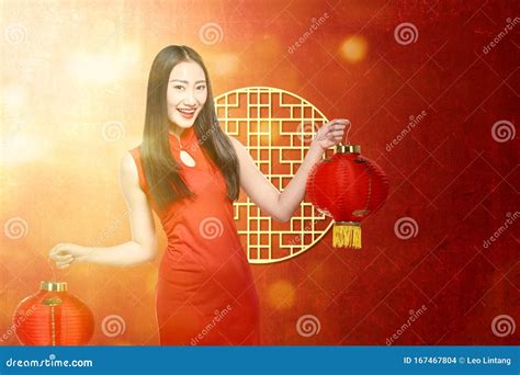 Asian Chinese Woman In A Cheongsam Dress Holding Chinese Lantern Stock