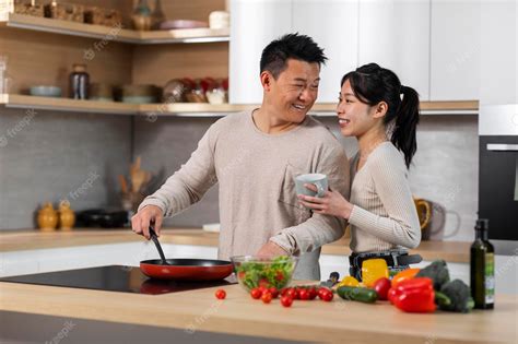 Premium Photo Loving Chinese Man Cooking For His Beautiful Girlfriend