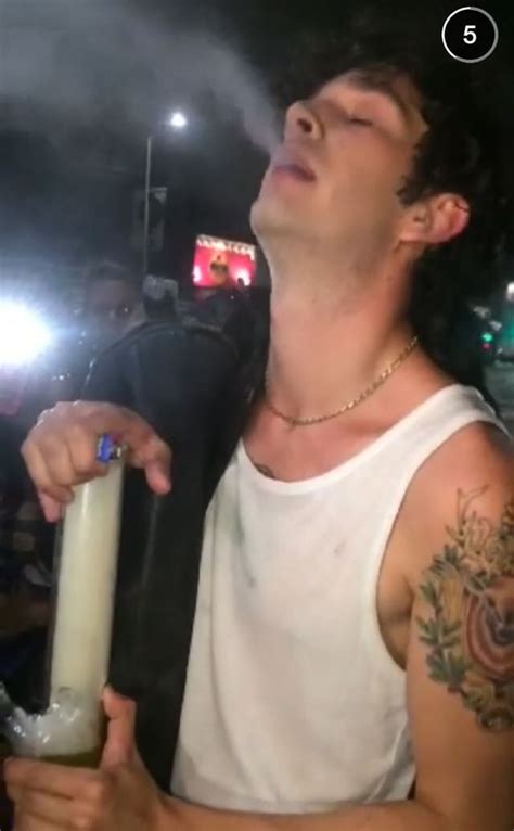 Watch 1975 Singer Matthew Healy Smoking From What Appears To Be A Bong