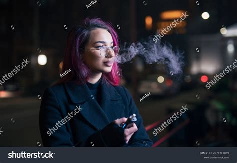 Unconventional Woman Pink Hair Smoking Electronic Stock Photo