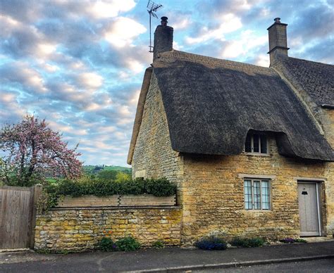 This cozy thatched roof cottage in a tiny British village stole my ...