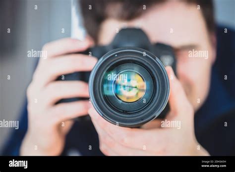 Photographer At Work Man Is Standing Behind A Professional Camera On A