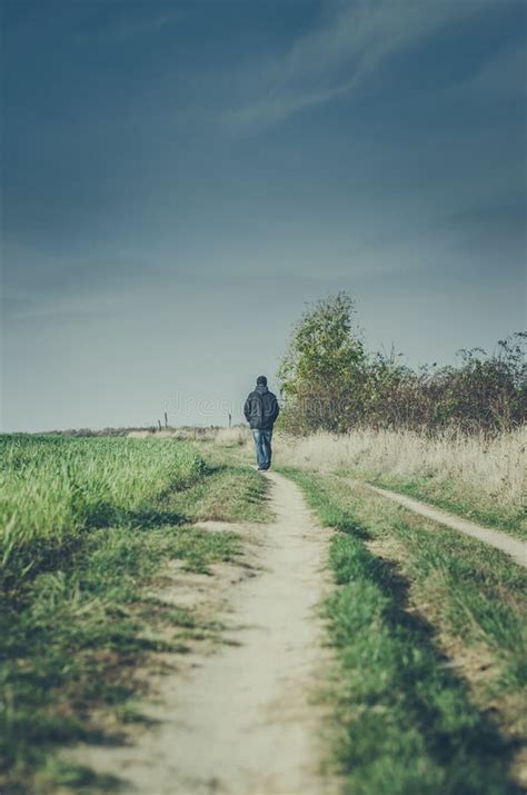One Man Alone Walking Away On Rural Path Stock Photo Image Of Destiny