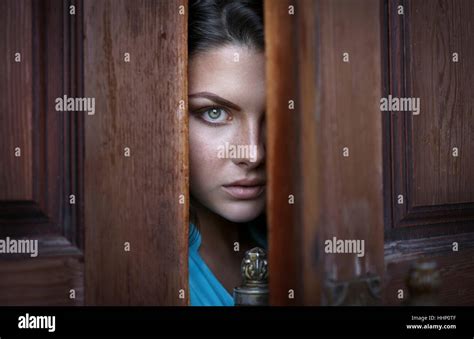 Caucasian Woman Peeking In Doorway Stock Photo Alamy