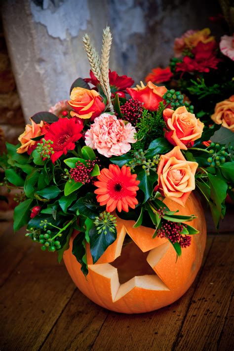 Beautiful Flowers Displayed Inside A Pumpkin Carved With Hearts ♥