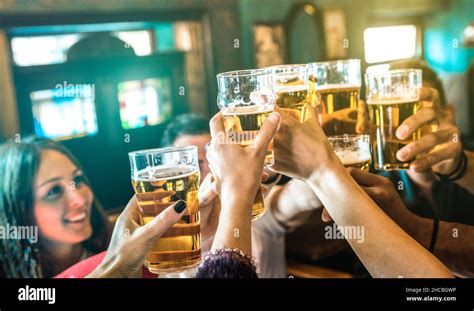 Friends Group Drinking And Toasting Beer At Brewery Bar Restaurant