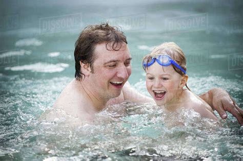 A Father And Son In A Swimming Pool Swimming Stock Photo Dissolve