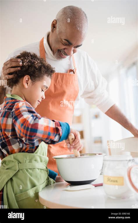 Mixed Race Grandfather And Grandson Baking In Kitchen Stock Photo Alamy