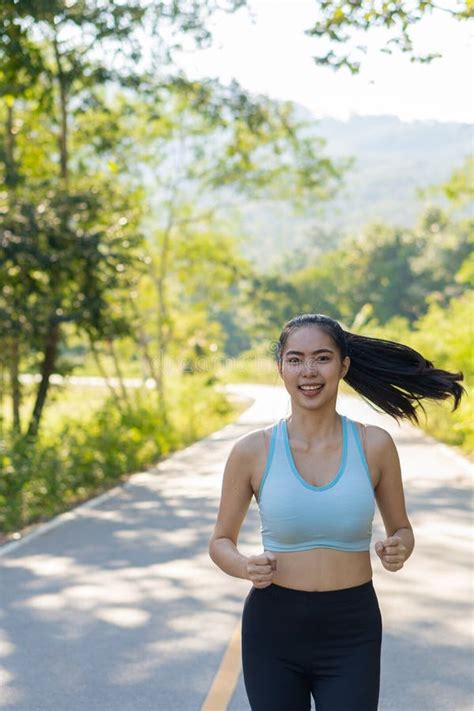 Asian Woman Jogging In The Park Healthy Lifestyle And Sports Concept