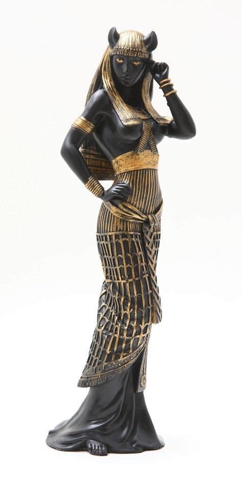 A Figurine Of A Woman In An Egyptian Dress With Her Hands On Her Head