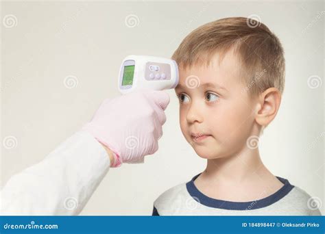 Doctor Measuring Temperature Little Kid With Infrared Thermometer Stock