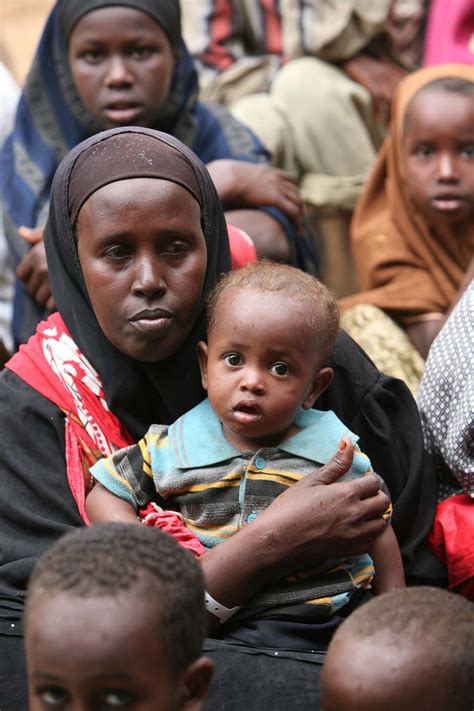 A Somali Refugee Woman With Her Child As She Waits To Be Admitted To