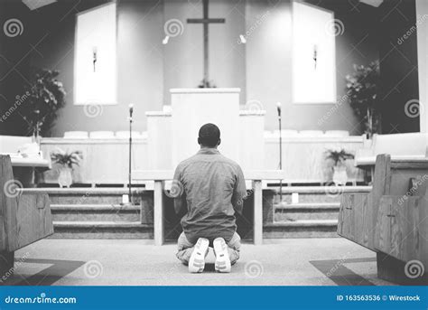 Man On His Knees Praying Not To Be Dismissed Stock Photography
