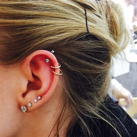 Beautiful Ear Adorned With Four Lobe And Three Helix Piercings The Top