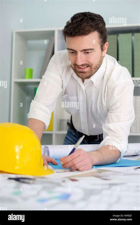 Architect Working On His Projects Papers In The Office Stock Photo Alamy