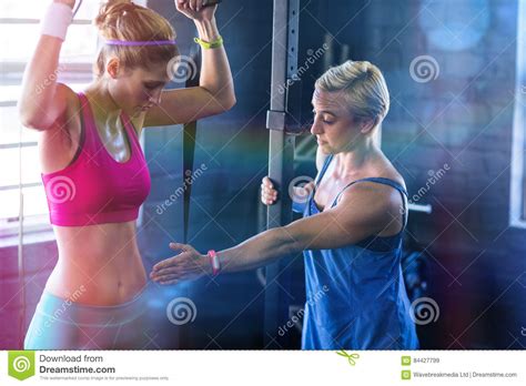 Female Trainer Instructing Woman In Gym Stock Image Image Of Exercise