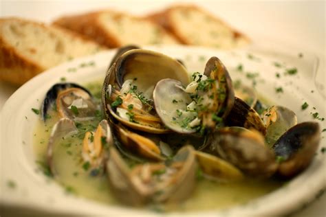 Minced clams mixed with butter, onions, parsley, and bread crumbs, spooned into half clam shells and baked. Recipe for Microwave-Steamed Clams or Mussels