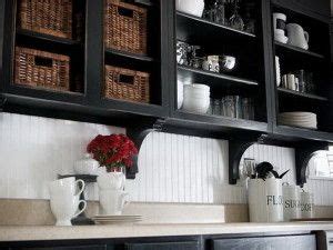 Customize your kitchen cabinet doors with these simple diy renovation tips. -white breadboard -contrasting black cabinets without ...