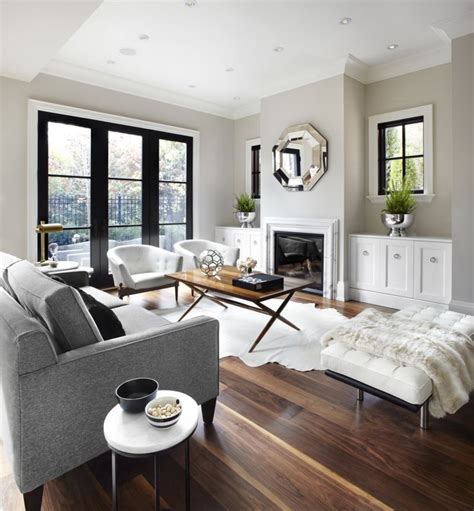 If you don't want to paint your living room white, but want to keep the space nice and bright, pale gray is a great alternative. austin-terrace-living-room-01 | Living room grey, Couches ...