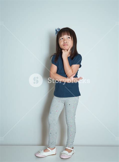 Beautiful Little Girl Looking Up And Thinking Royalty Free Stock Image