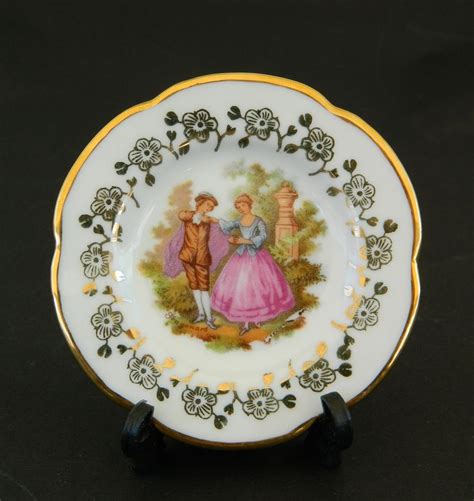 A Plate With An Image Of A Man And Woman On It Sitting On A Black Surface
