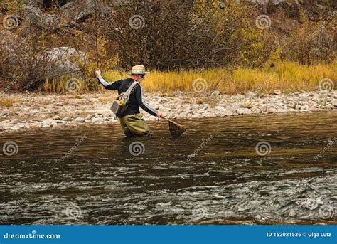 Fisherman Crossing The Mountain Stream In The Fall Stock Photo Image