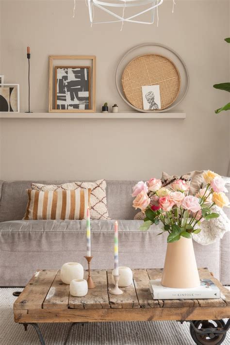 A Living Room Filled With Furniture And Flowers On Top Of A Coffee