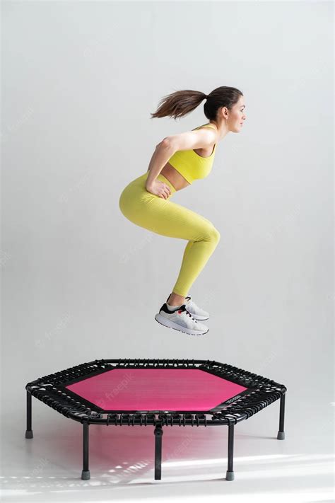 Download Girl Exercising On A Pink Hexagonal Trampoline Wallpaper