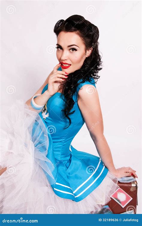 Sailor Pin Up Girl With Bright Make Up Sitting On A Suitcase Royalty