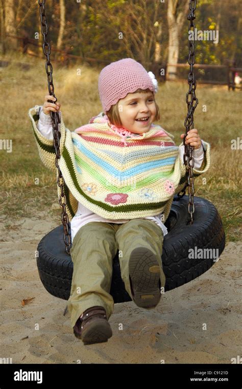 Girl Swinging On A Tire Swing Stock Photo Alamy