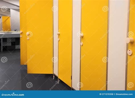 Public Toilet Interior With Bright Yellow Stalls Stock Photo Image Of