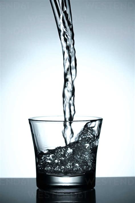 Water Being Poured Into A Glass Stock Photo
