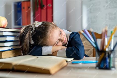Premium Photo Little Student Is Sleeping On The School Desk Because