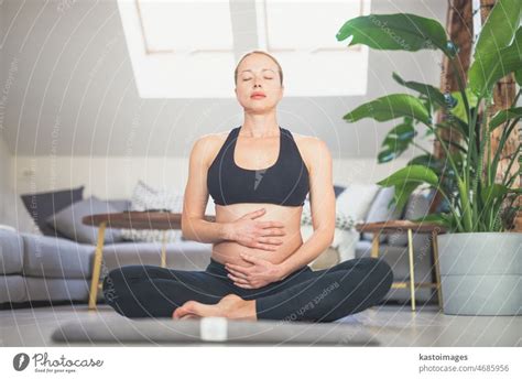 Young Beautiful Pregnant Woman Training Yoga Caressing Her Belly