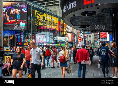 Visitors And Tourists Enjoying Themselves At Crowded Times Square 42nd