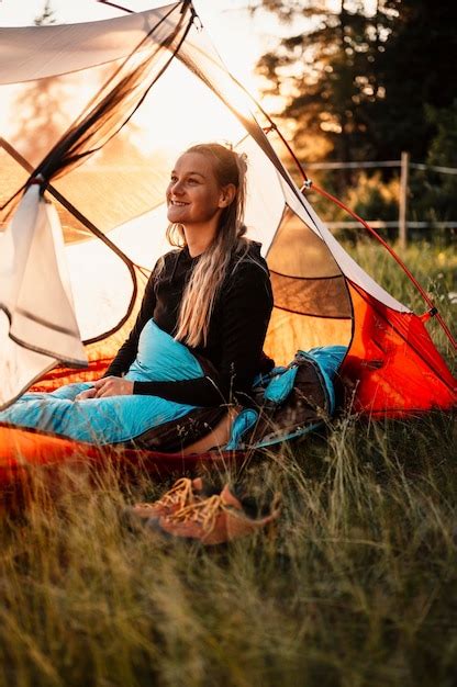 Premium Photo Woman Relaxing And Lie In A Sleeping Bag In The Tent Sunset Camping In Forest