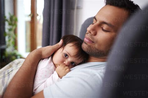 Affectionate Father Hugging His Baby Babe At Home Stock Photo