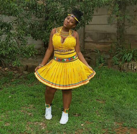 zulu girl in yellow crop top and patterned skirt with white sneakers for umemulo clipkulture