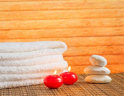 Spa Massage Border Background With Towel Stacked Stone And Red Candles Warm Atmosphere Stock