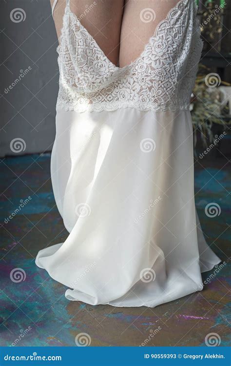 Young Female Pulling Down Short Dress Over Derriere Stock Image