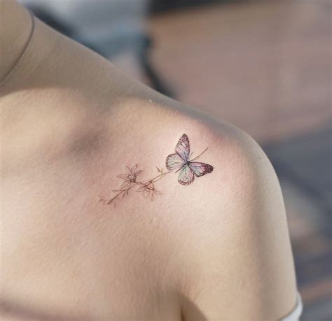 A Woman With A Butterfly Tattoo On Her Shoulder