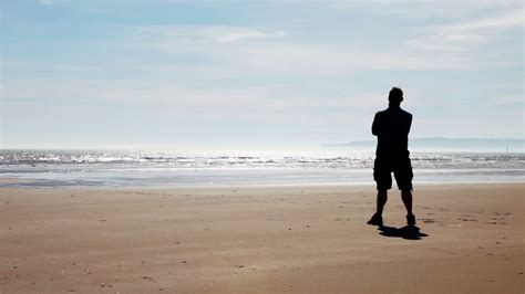 Embracing Freedom Solitary Man Standing On A Beach Stock Video Footage