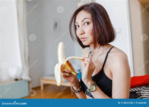 Woman Eating Banana In Her Apartment Stock Photo Image Of Girl