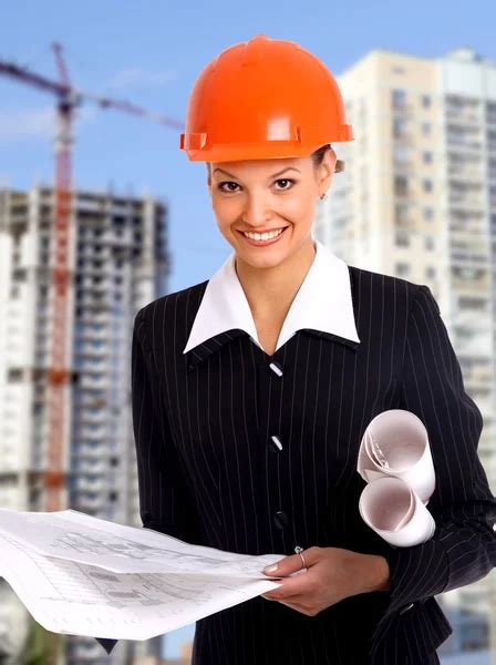 Smiling Young Female Architect Holding Blueprints Stock Photo By