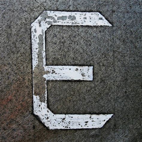 The Letter E Is Made Out Of White Paint And Has An Arrow Pointing To It